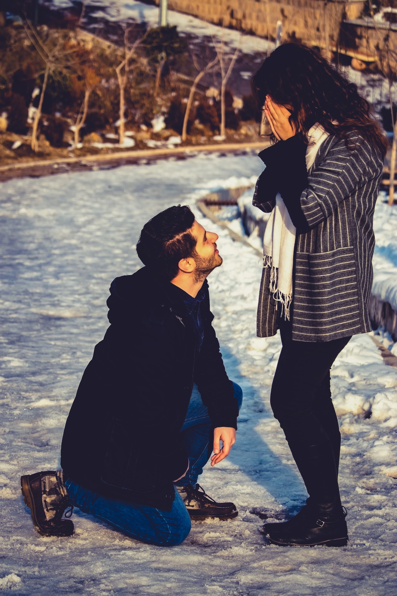 man-kneeling-in-front-of-woman-878668